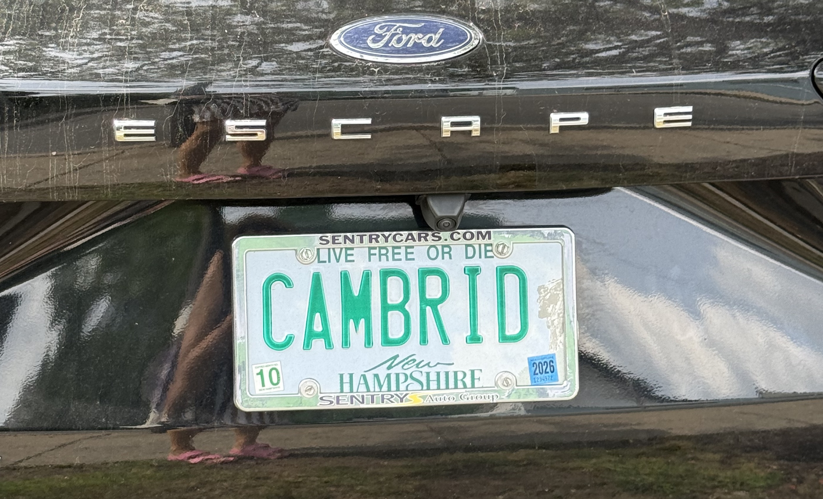 The license plate reads CAMBRID. It is a New Hampshire license plate with the slogan 